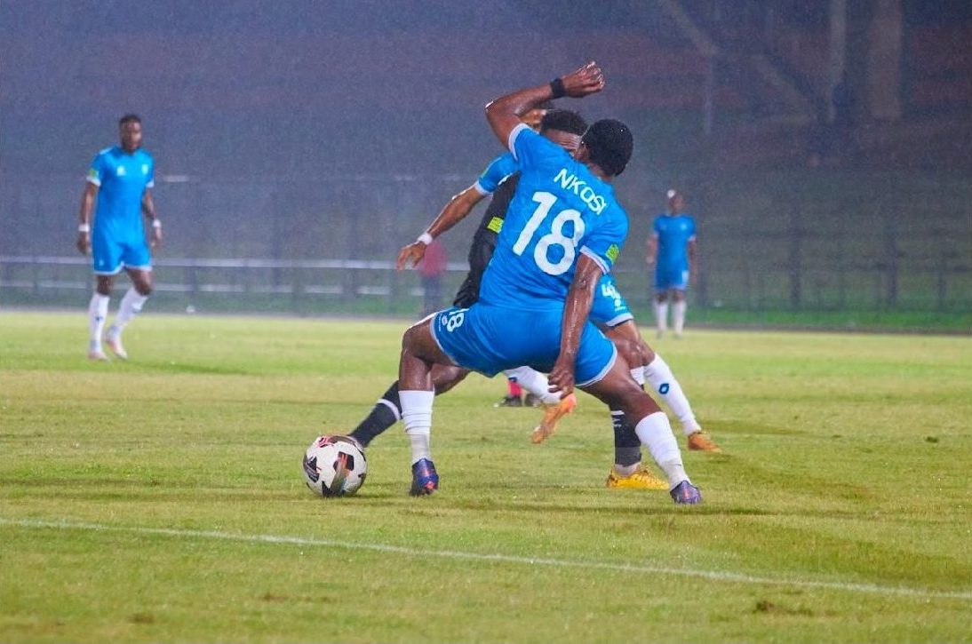 Nkosi taking on a defender at night